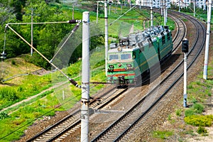 Single electric locomotive in industrial zone of city