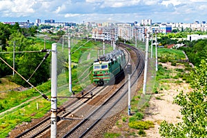 Single electric locomotive in industrial zone of city