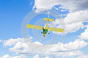 Light aircraft flying over blue sky. Single-engine