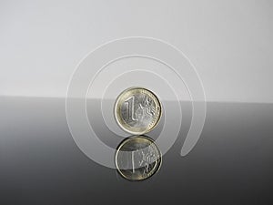Single Euro coins on grey background