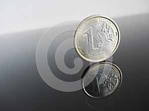 Single Euro coins on grey background