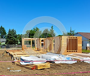 Single family home under construction on blue sky background