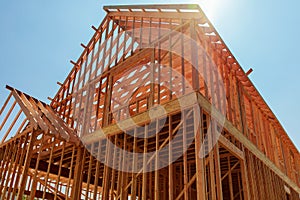 A single family home under construction. The house has been framed and covered in plywood.