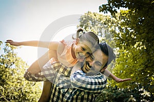 Single father on meadow with his daughter.