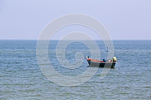 Single fishery boat floating on sea