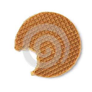 Single fresh baked stroopwafel, syrup waffle, with a bite out of it isolated on white background