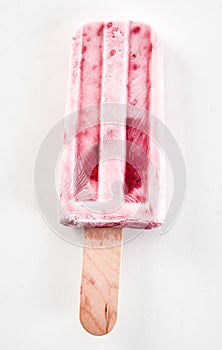 Single frozen iced fresh strawberry popsicle