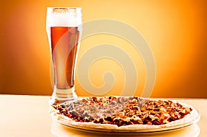 Single glass of beer and pizza