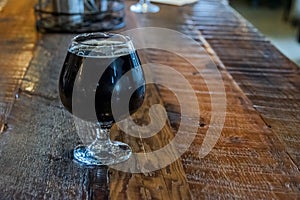 Single Glass of Beer on the Wooden Table