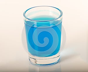 Single glass of blue drink kamikaze, thick glass, closeup, blue