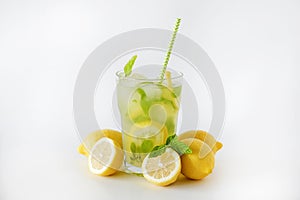Single glass of iced lemonade. Studio shot of refreshing non alcoholic mojito drink with lemon slices, mint leaves and ice