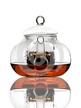 Single glass teapot with tea, isolated on white background.