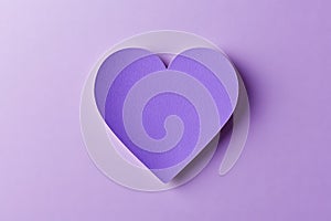 Single glittering purple heart shape on a soft purple background