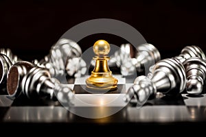 Single gold pawn chess surrounded by a number of fallen silver c