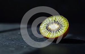 Single Green Kiwi Half on Slate photo