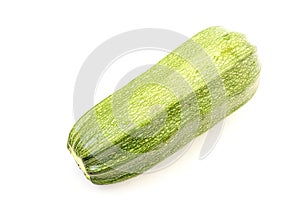 Single green zucchini isolated on white