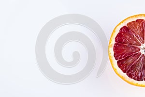 Single half of a blood orange isolated on white