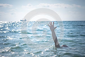 Single hand of drowning man in sea asking for help