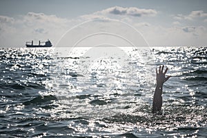 Single hand of drowning man in sea asking for help