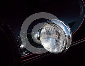 Single headlight and pinstrip on vintage 1920`s-30 car: photo