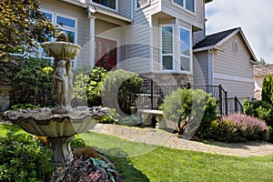 Single Home Frontyard with Manicured Garden and Green Lawn photo