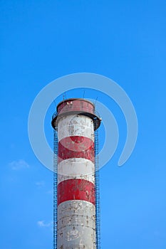 A single industrial chimney, blue sky