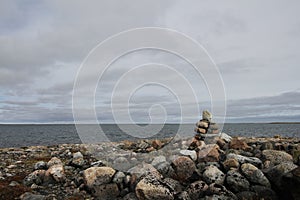 Single Inukshuk or Inuksuk along the arctic coast near Arviat