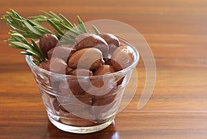 Single jar of black kalamata olives and rosemary