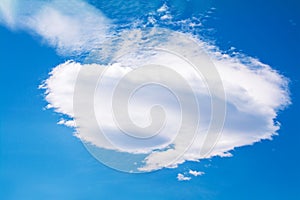 A single lenticular cloud in blue sky