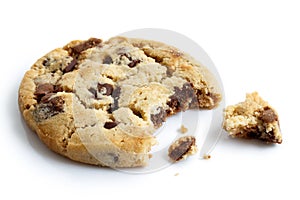 Single light chocolate chip cookie, bite missing with crumbs, is