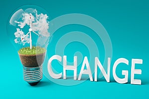 single lightbulb with minature wind turbine inside green soil and clouds renewable clean energy concept 3D Illustration
