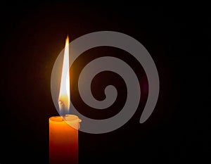 A single lit candle in the darkness, representing hope, remembrance, and the enduring light of peace in times of conflict