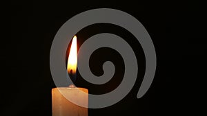 Single lit candle with flame