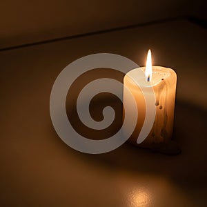 Wax drips on the side casting a warm glow and soft shadow on a