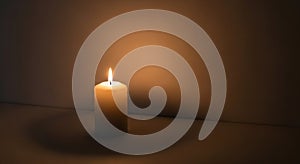 A single lit candle stands on