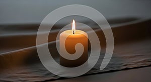 A single lit candle stands on