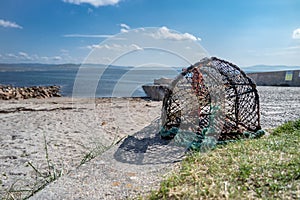 Single Lobster trap on pier close to the ocean