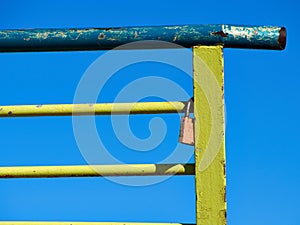 Single love lock on colorful metal rail fence