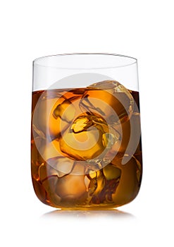 Single malt whiskey in large luxury crystal glass with ice cubes on white background