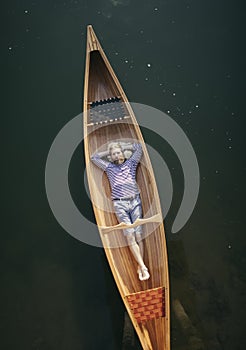 Single man relaxing in the canoe