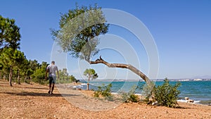 Single man taking a morning walk near the sea