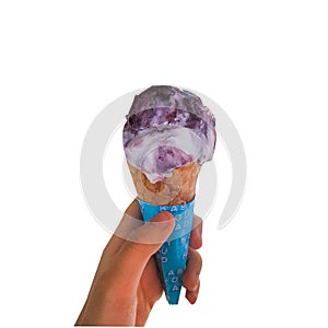 Single melting purple and vanilla ice cream scoop flavor in waffle cone in hand holding on white