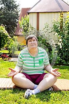 single mentally disabled woman is doing some relaxation yoga exercises photo