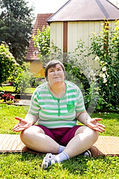 single mentally disabled woman is doing some relaxation yoga exercises