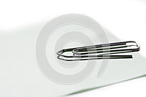 Single metallic paper clip isolated