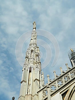 Single Milan Duomo spire with La Madonnina further away in corne