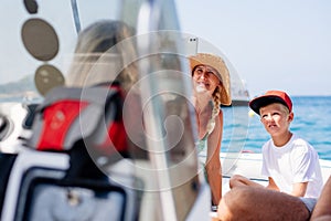 Single mother takes a selfie with her little son while they are on a speedboat