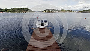Single motorboat tied to dock in Oslo Fjord.