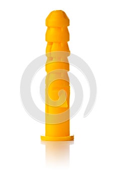 Single new, unused, yellow plastic wall plug dowel over white