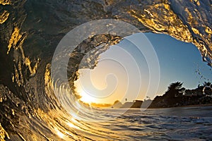 A Single Ocean Wave Tube at Sunset on the Beach